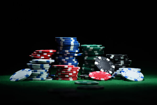 Close up shot of group poker chips on green table